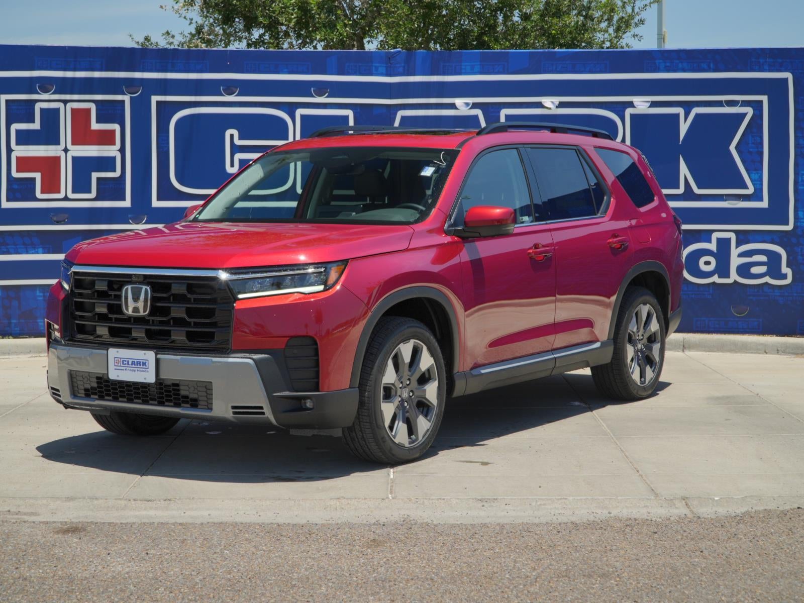 2026 Honda Pilot Touring in Radiant Red Metallic II — front three-quarter view